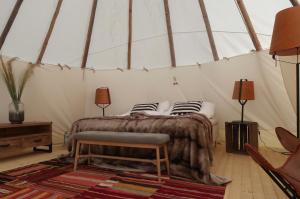 een slaapkamer met een bed in een tent bij Hölick Havsresort & spa in Hudiksvall