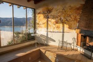 a room with a fireplace and a wall with windows at the best view in Valle de Bravo in Valle de Bravo