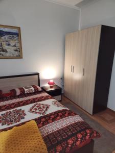 a bedroom with a bed and a large cabinet at PANTELI APART HOUSE in Aheloy