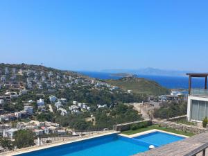 a view of a villa with a swimming pool at İBAK Apartments in Gümüşlük