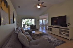 a living room with a couch and a flat screen tv at Florinda 3bdr/2bth 2car garage with New Pool in Sarasota