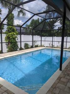 a large blue swimming pool with a pergola at Florinda 3bdr/2bth 2car garage with New Pool in Sarasota