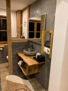 a bathroom with a sink and a mirror at Appartement Buchwald -Obinghof- in Maishofen