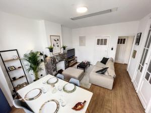 a living room with a table and a couch at Cosy Apartment Brussels - City Center in Brussels