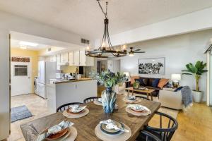 a dining room and living room with a table and chairs at 5 Mi to Ocotillo Golf Course Chic Sun Lakes Home! in Sun Lakes