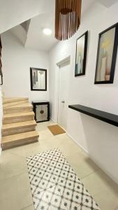 a living room with stairs and a rug at Apartamento Retama Laguna Centro in Las Lagunas