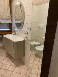 a bathroom with a sink and a toilet and a mirror at ARIA DI CASA in Verona
