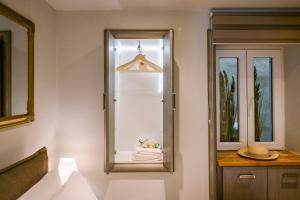 a bathroom with a mirror and a towel at Maestro suite in Corfu +5 photos