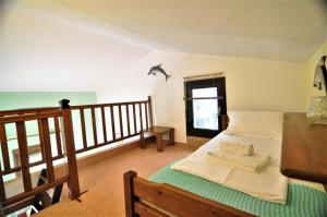 A bed or beds in a room at Zennova #23 Nikiti Family Green Nest
