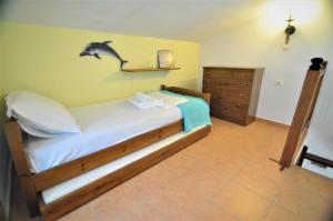 A bed or beds in a room at Zennova #23 Nikiti Family Green Nest