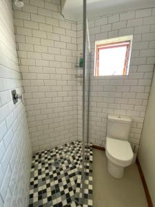 a bathroom with a toilet and a window at Lovely Private room close to campus in Stellenbosch