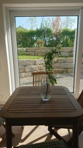 a wooden table with a vase with a plant on it at Ruhezeit in Stockach
