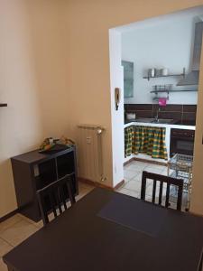 a kitchen with a black table and chairs in a kitchen at Simply Home in Novara