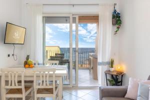 a living room with a table and a balcony at IL Castello incantato in Castelsardo