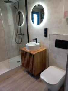 a bathroom with a sink and a shower and a toilet at Przystanek Mazury.Makosieje in Makosieje +57 photos