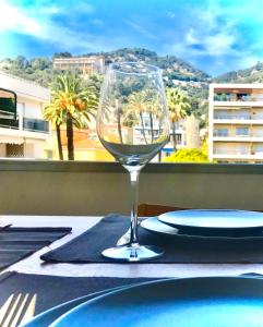 a glass of wine sitting on top of a table at Beaulieutiful City Center apartment in Beaulieu-sur-Mer