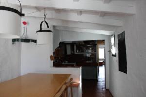 a kitchen with a wooden counter top in a room at Casa típica menorquina cèntrica amb encant in Fornells