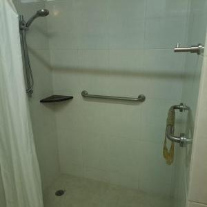 a bathroom with a shower with a shower curtain at Howard Johnson by Wyndham Toluca in Toluca