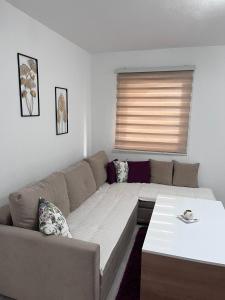 a living room with a couch and a table at Apartman Kasic in Konjic