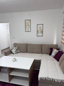 a living room with a couch and a table at Apartman Kasic in Konjic