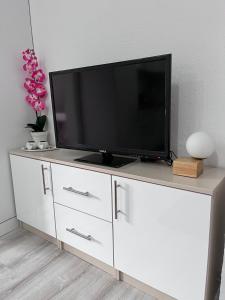 a television on a white dresser in a room at Apartman Kasic in Konjic