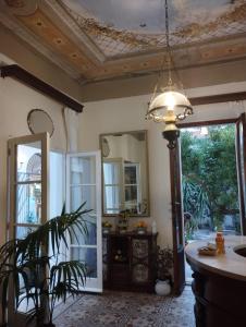 a living room with a ceiling and a light fixture at Hotel Golfo Azzurro in Capoliveri