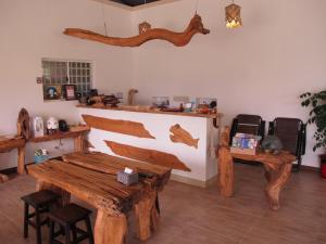 a room with a wooden table and bench in it at Woodenfish in Chenggong +18 photos