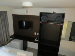 a small black refrigerator in a hotel room at Minuano Hotel Express próx Orla Lago Guaíba, Mercado Público, 300 m Rodoviária in Porto Alegre