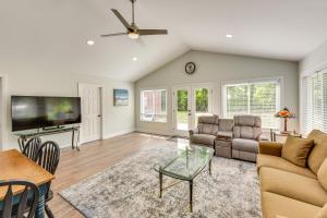 a living room with a couch and a tv at Charming Bluffton Vacation Home with Smart TVs! in Bluffton