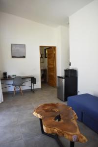 a living room with a blue couch and a wooden coffee table at Blue Window Boutique Villas Hotel in Playa Junquillal
