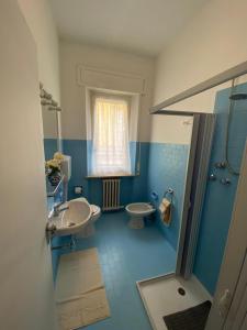 a blue bathroom with a sink and a toilet at mare blu in Sirolo