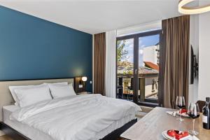 a bedroom with a large bed and a large window at Uni88 ApartHotel in Bucharest