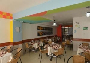 a restaurant with tables and chairs and a rainbow ceiling at Hotel San Fermin Pereira in Pereira