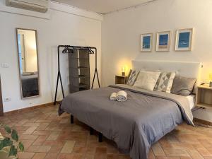 a bedroom with a bed with two shoes on it at Appartements dans agréable maison de ville centre historique de Rimini in Rimini