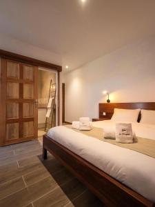 a bedroom with a large bed with two pillows on it at Gîte le Fouquet in Cilaos