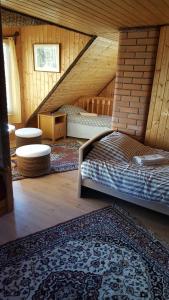 a attic room with a bed and a rug at My little happy place in Undva
