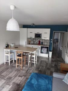 a kitchen and dining room with a table and chairs at Les mésanges in Laquenexy