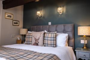 a bedroom with a bed with a deer pillow at Sunnyside Guest House in Keswick