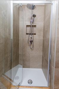 eine Dusche mit Glastür im Bad in der Unterkunft Schiaparelli 4 in Mailand