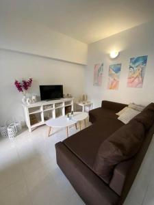 a living room with a couch and a tv at Magio House in Ixia