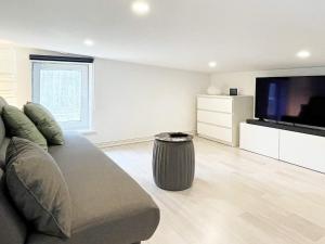 a living room with a couch and a flat screen tv at 3 person holiday home in NISSAFORS-By Traum in Böle