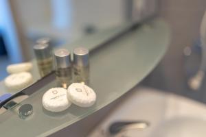 a shelf with three laboratory items on it at Appartamento Moderno con vista mare in Castelsardo +44 photos