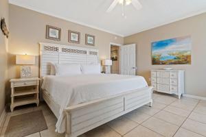 a bedroom with a large white bed and two night stands at Phoenix VIII 1406 in Orange Beach +41 photos