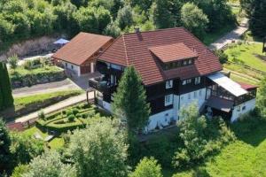 an aerial view of a large house with a roof at Cozy holiday apartment in the Black Forest in Dachsberg im Schwarzwald
