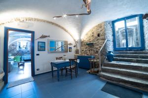 a room with stairs and a table and chairs at U Catoiu in Scilla