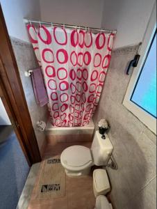 a bathroom with a toilet and a shower curtain at Casa di nonna in Kavalloúrion