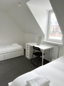 a bedroom with a desk and a bed and a laptop at Relax Inn in Liverpool