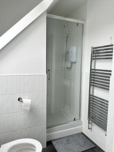 a bathroom with a shower and a toilet at Relax Inn in Liverpool