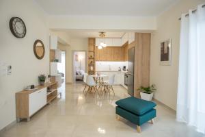 a living room and kitchen with a blue ottoman at Vonitsa Luxury Apartments in Vonitsa