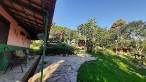 een patio met een stenen loopbrug naast een tuin bij Rancho Ecologico Oasis de Luz in Abadiânia